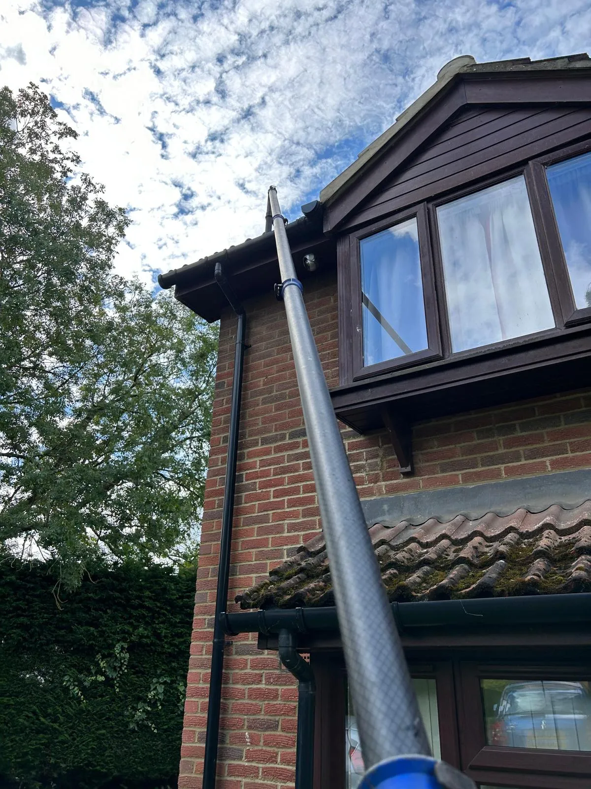 A metal pole sticking out of the side of a building.