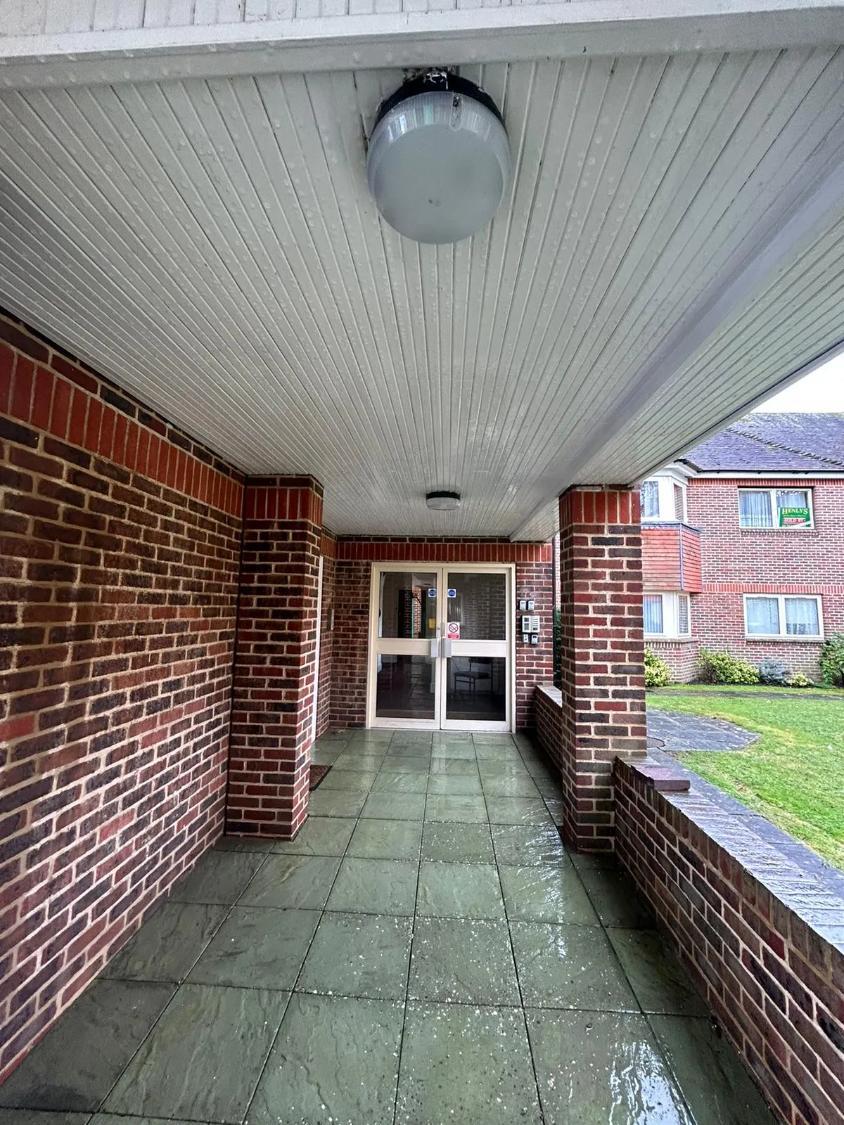 A walkway leading to a building with a door.