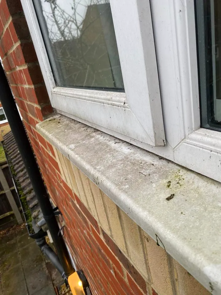 A close up of a window on a brick building.